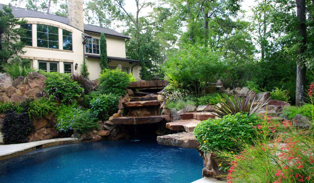 Gorgeous backyard oasis with stone waterfall swimming pool