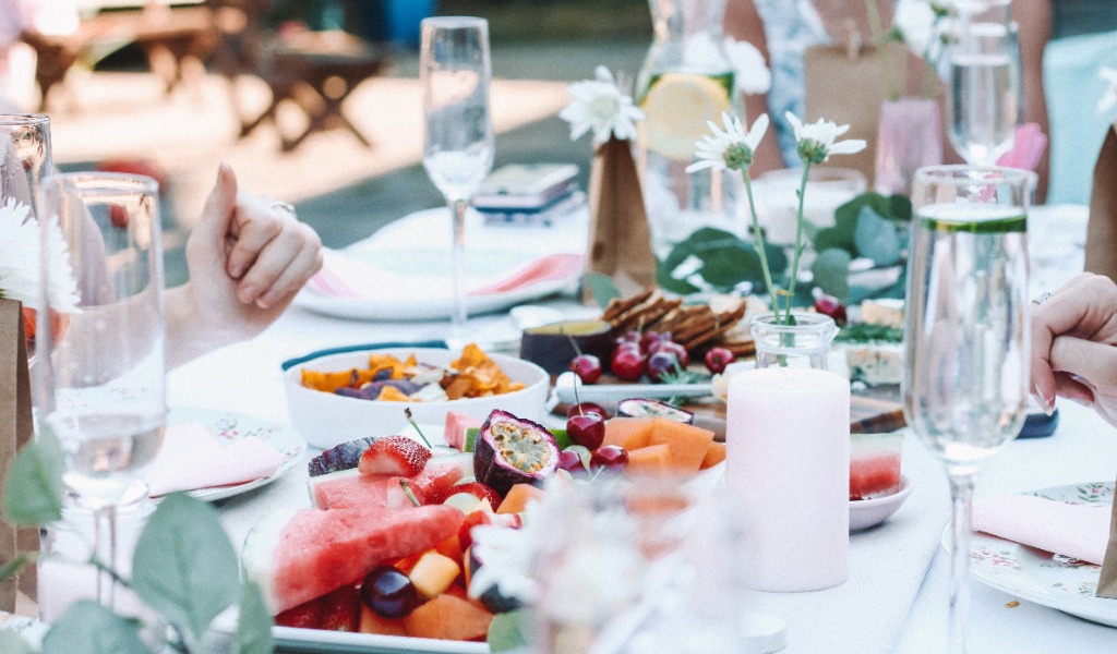 summer garden party table with fruit and champagne