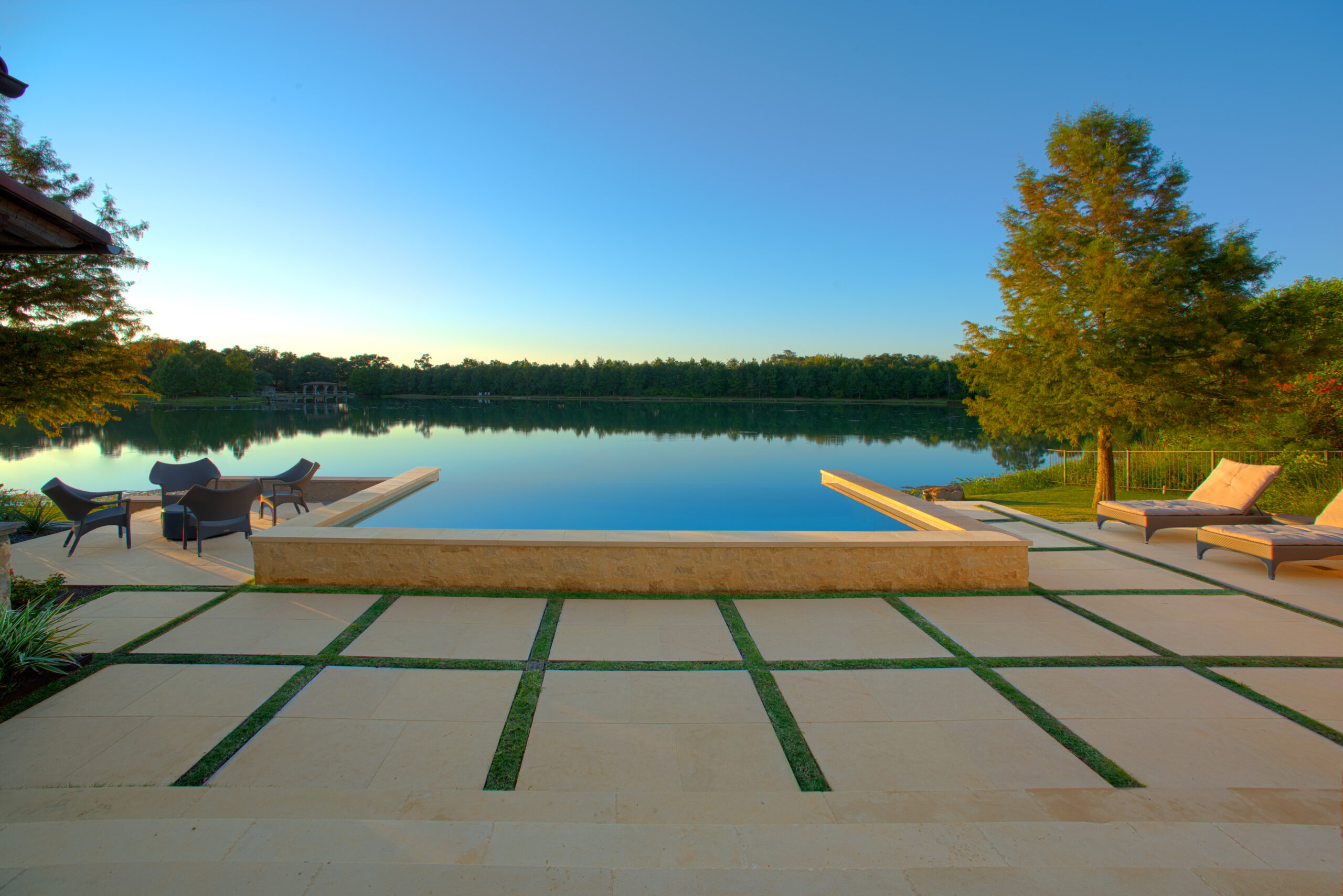An infinity pool designed and built by Prewett, Read & Associates overlooking a lake.