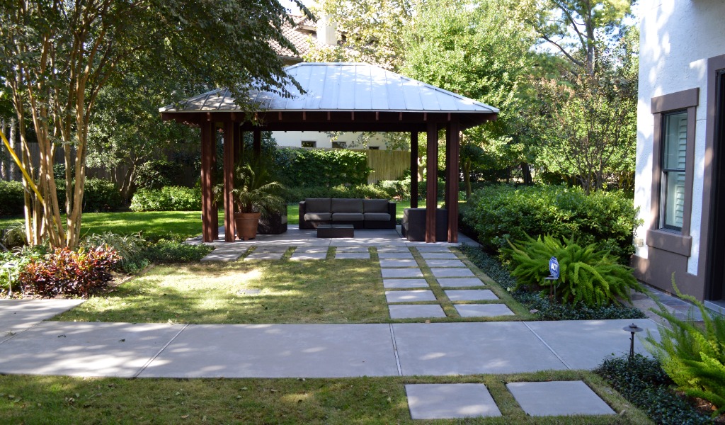 Custom hardscaping including stepping stones, walkway and wood structure.