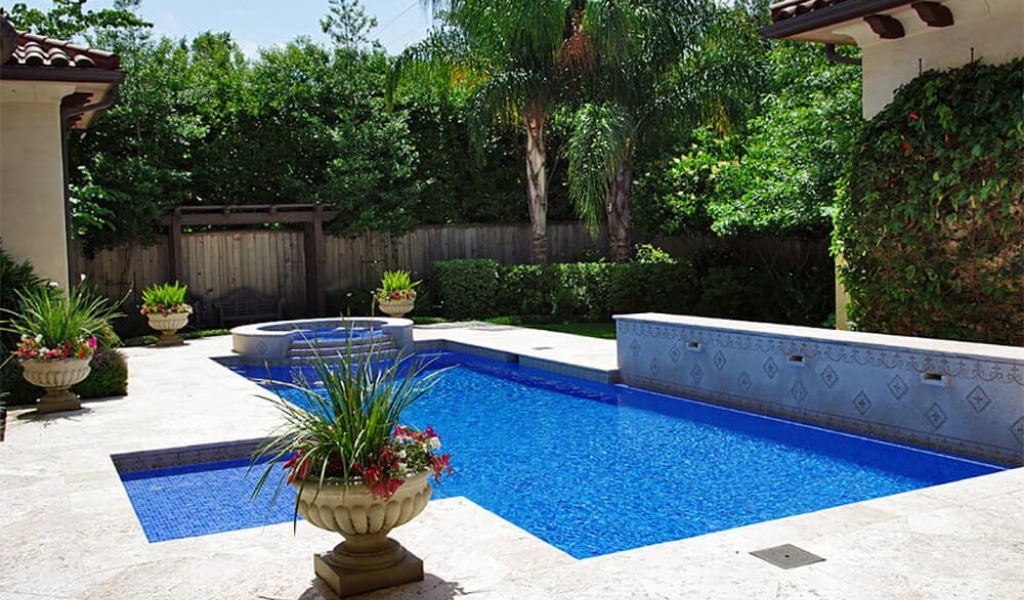 Custom backyard swimming pool construction inspired by Mediterranean design.