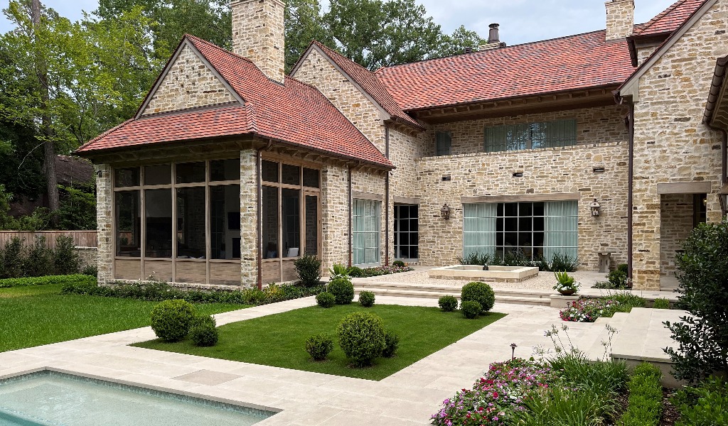 Custom designed hardscaping, including a swimming pool and patio, at a Houston area home.